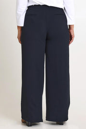 Model Ashleigh wearing size 16 of The Tab Detail Tailored Pant in colour Black (Black), from the back