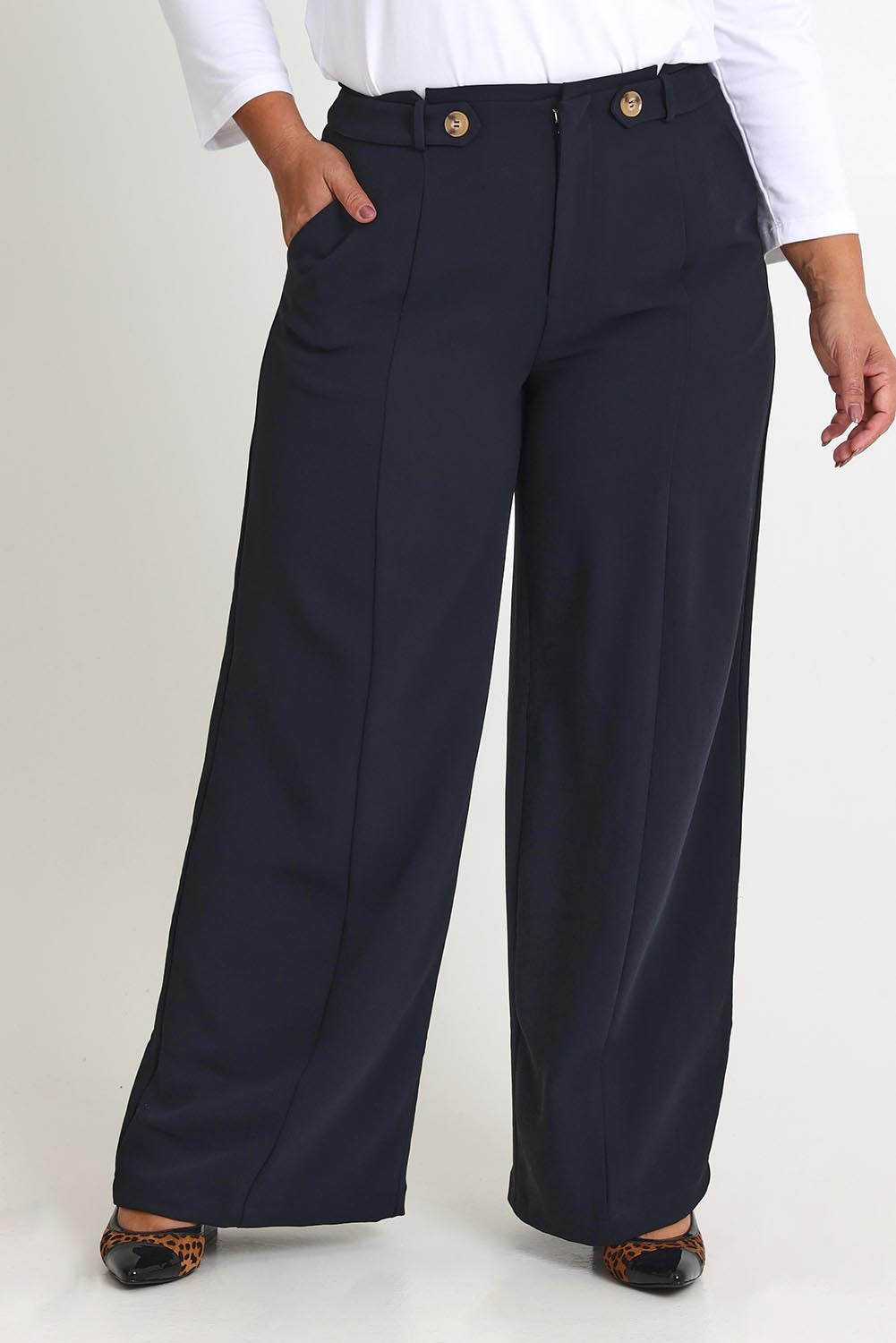 Model Ashleigh wearing size 16 of The Tab Detail Tailored Pant in colour Black (Black), from the front, cropped image