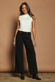Model Madeline wearing size 10 of The Tab Detail Tailored Pant in colour Black (Black), from the front, showing the whole outfit