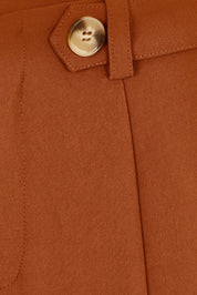 Product shot of The Tab Detail Tailored Pant in colour Rust, detail