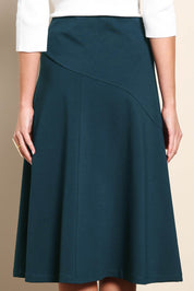 Model Madelinec wearing size 10 of the The Ponte Curve Seam Pull On Skirt – Lagoon in colour Lagoon, in a cropped view