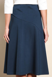 Model Madelinec wearing size 10 of the The Ponte Curve Seam Pull On Skirt – Lagoon in colour Lagoon, in a cropped view