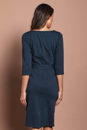 Model Madeline wearing size 10 of The Square Neck Ponte Dress in colour Lagoon (Green), from the back