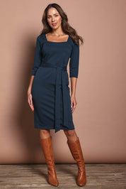 Model Madeline wearing size 10 of The Square Neck Ponte Dress in colour Lagoon (Green), from the front, showing the whole outfit