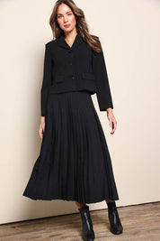 Model Madelinec wearing size 10 of the The Luxe Pleated Skirt – Black in colour Black, from the front