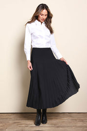 Model Madelinec wearing size 10 of the The Luxe Pleated Skirt – Black in colour Black, from the front