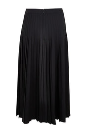 Product shot of the The Luxe Pleated Skirt – Black in colour Black, from the back