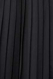 Product shot of the The Luxe Pleated Skirt – Black in colour Black, showing detail