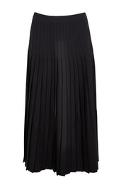 Product shot of the The Luxe Pleated Skirt – Black in colour Black, from the front