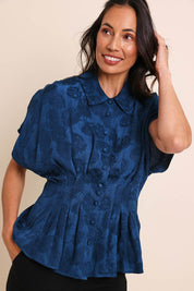 Model Amandam wearing size 10 of the The Jacquard Pleated Shirt - Darkpeacock in colour Darkpeacock, in a cropped view