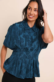 Model Amandam wearing size 10 of the The Jacquard Pleated Shirt - Darkpeacock in colour Darkpeacock, in a cropped view