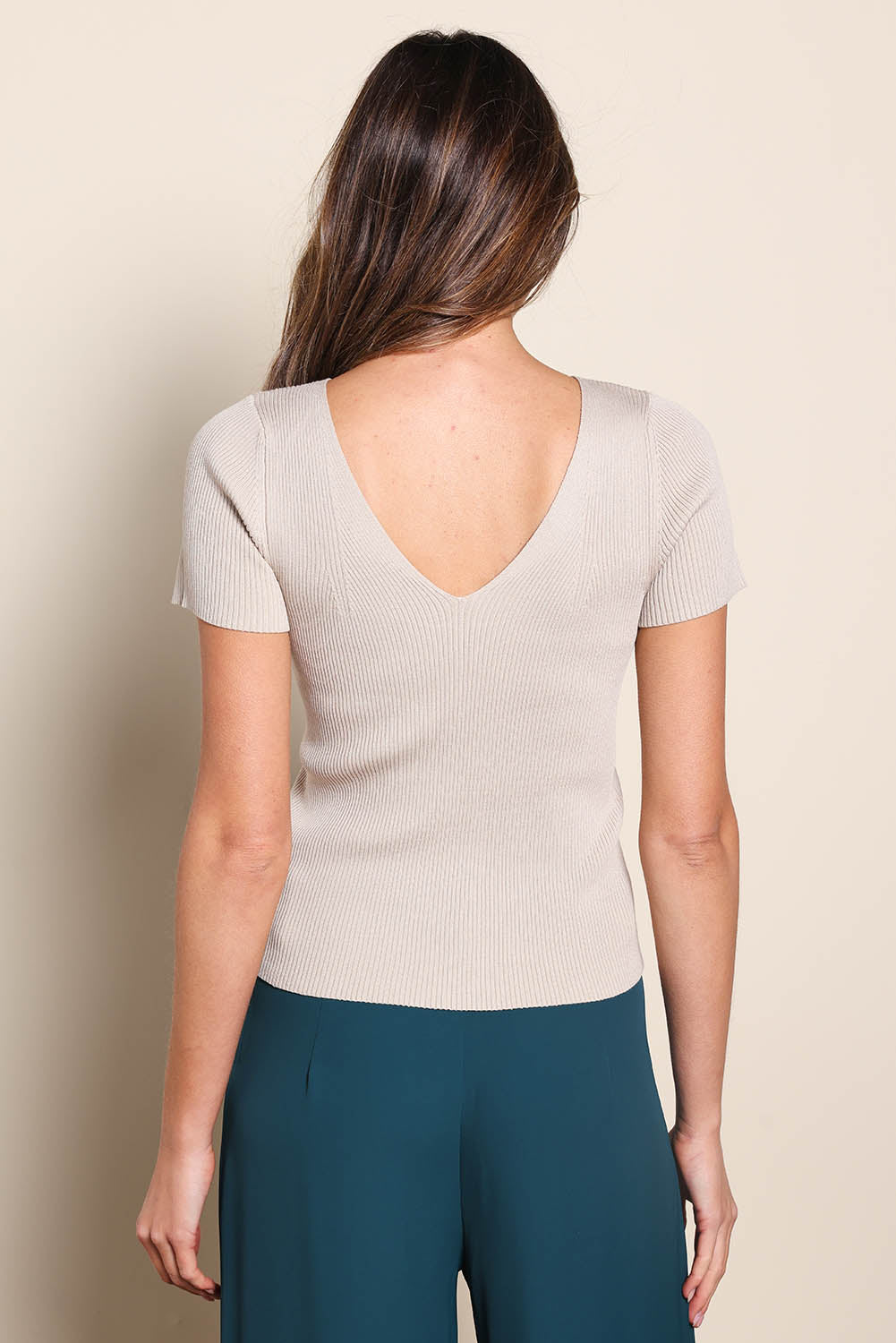 Model Madelinec wearing size 10 of the The Reversible Rib Knit Top – Biscotti in colour Biscotti, from the back