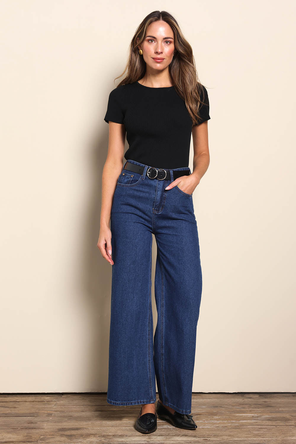 Model Madelinec wearing size 10 of the The Reversible Rib Knit Top – Black in colour Black, from the front
