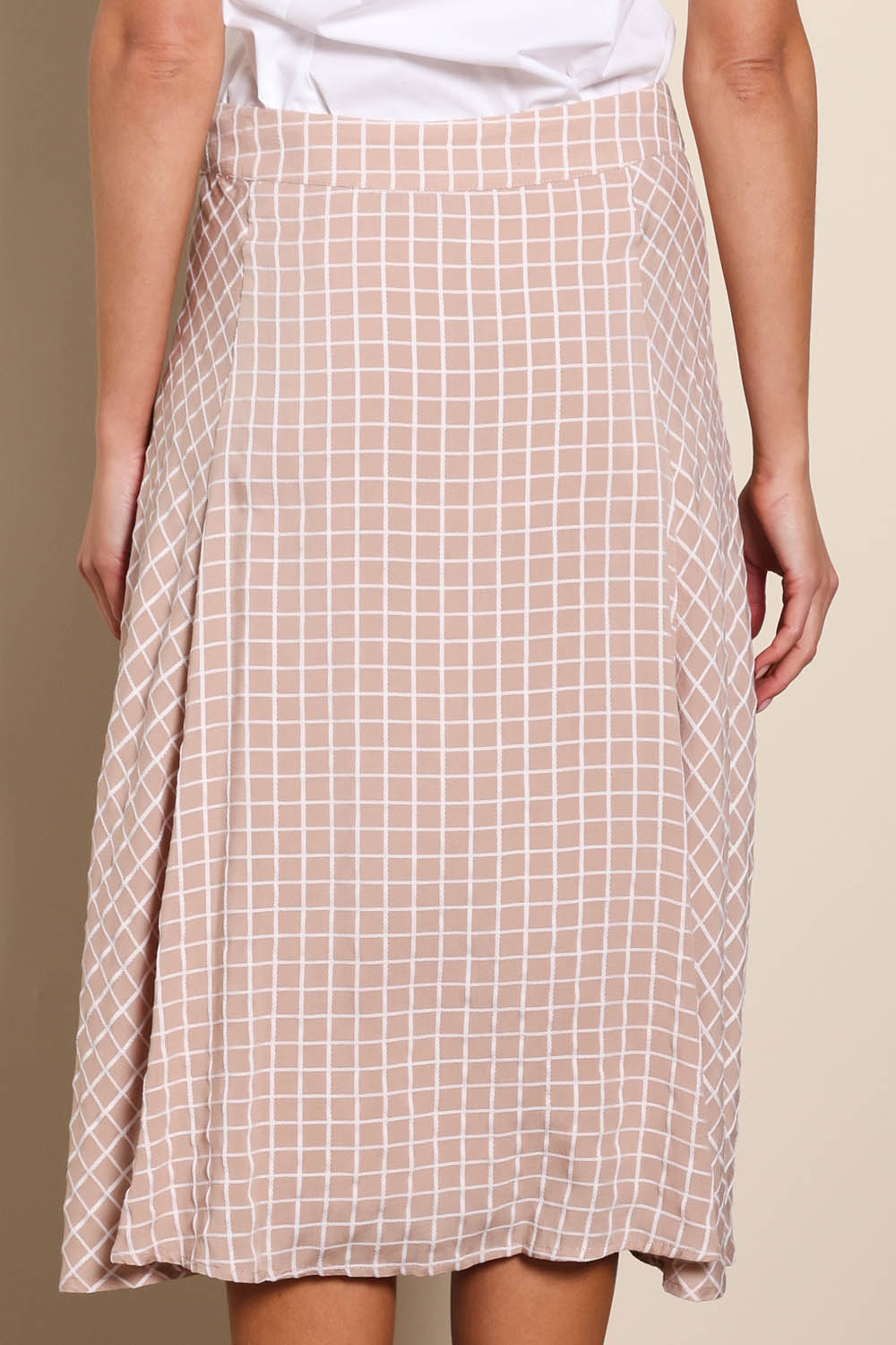 Model Madelinec wearing size 10 of the The Bias Panel Check Skirt - Sand in colour Sand, from the back