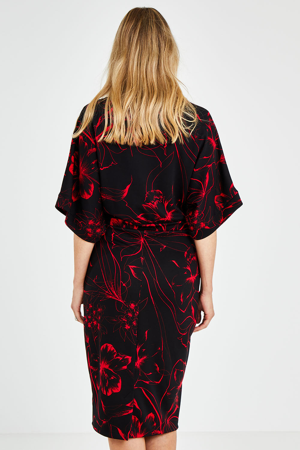 Model Kelly wearing size 10 of The Printed Kimono Sleeve Pencil Dress in colour Redfleur (Black), from the back