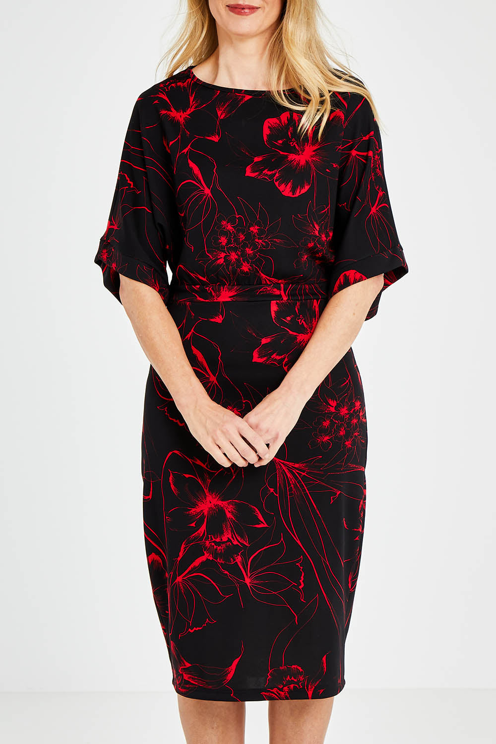 Model Kelly wearing size 10 of The Printed Kimono Sleeve Pencil Dress in colour Redfleur (Black), from the front, cropped image