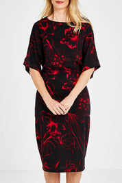 Model Kelly wearing size 10 of The Printed Kimono Sleeve Pencil Dress in colour Redfleur (Black), from the front, cropped image