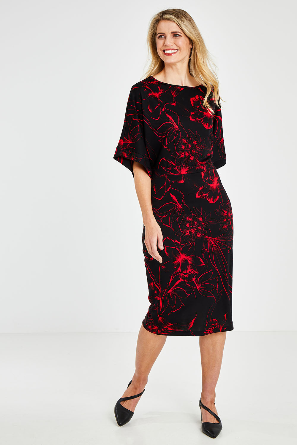 Model Kelly wearing size 10 of The Printed Kimono Sleeve Pencil Dress in colour Redfleur (Black), from the front, showing the whole outfit