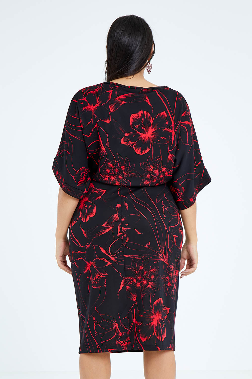 Model Sasha-Lee wearing size 16 of The Printed Kimono Sleeve Pencil Dress in colour Redfleur (Black), from the back