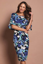 Model Madeline wearing size 10 of The Printed Kimono Sleeve Pencil Dress in colour Oceanbloom (Blue), from the front, cropped image