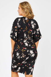 Model Jess wearing size 14 of The Printed Kimono Sleeve Pencil Dress in colour Garden (Black), from the back