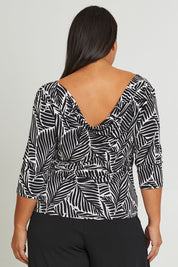 Model Ashleigh wearing size 16 of The Printed Reversible Cowl Neck Top in colour Leaf (Black), from the back