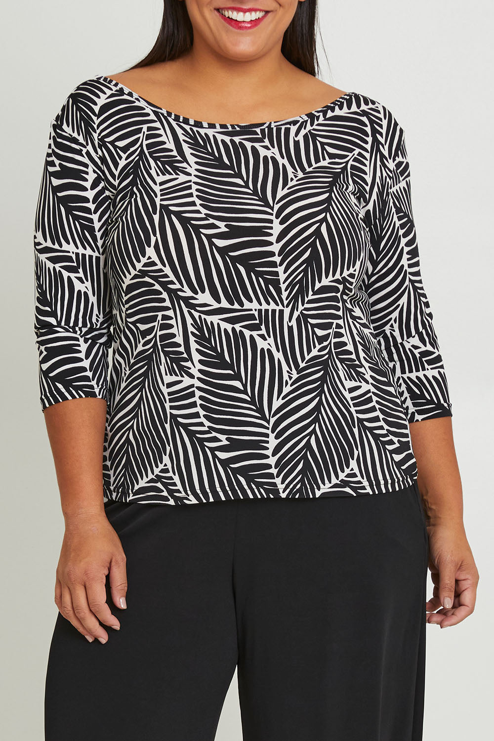 Model Ashleigh wearing size 16 of The Printed Reversible Cowl Neck Top in colour Leaf (Black), from the front, cropped image