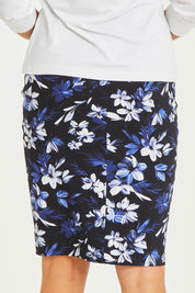 Model Stacey wearing size 10 of The Tube Skirt in colour Fleur (Blue), from the back