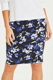 Model Stacey wearing size 10 of The Tube Skirt in colour Fleur (Blue), from the front, cropped image