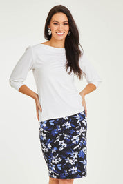 Model Stacey wearing size 10 of The Tube Skirt in colour Fleur (Blue), from the front, cropped image