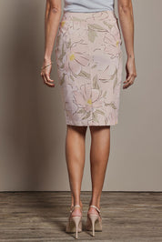 Model Amanda wearing size 10 of The Tube Skirt in colour Blushbloom (Pink), from the back