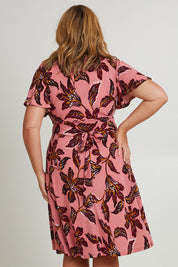 Model Fiona wearing size 16 of The Printed Jersey Faux Wrap Dress in colour Pinkfleur (Pink), from the back