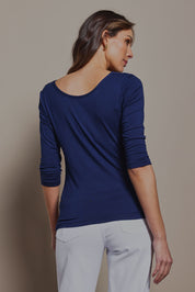 Model Madeline wearing size 10 of The Reversible Cowl Neck Top in colour Navy (Blue), from the back
