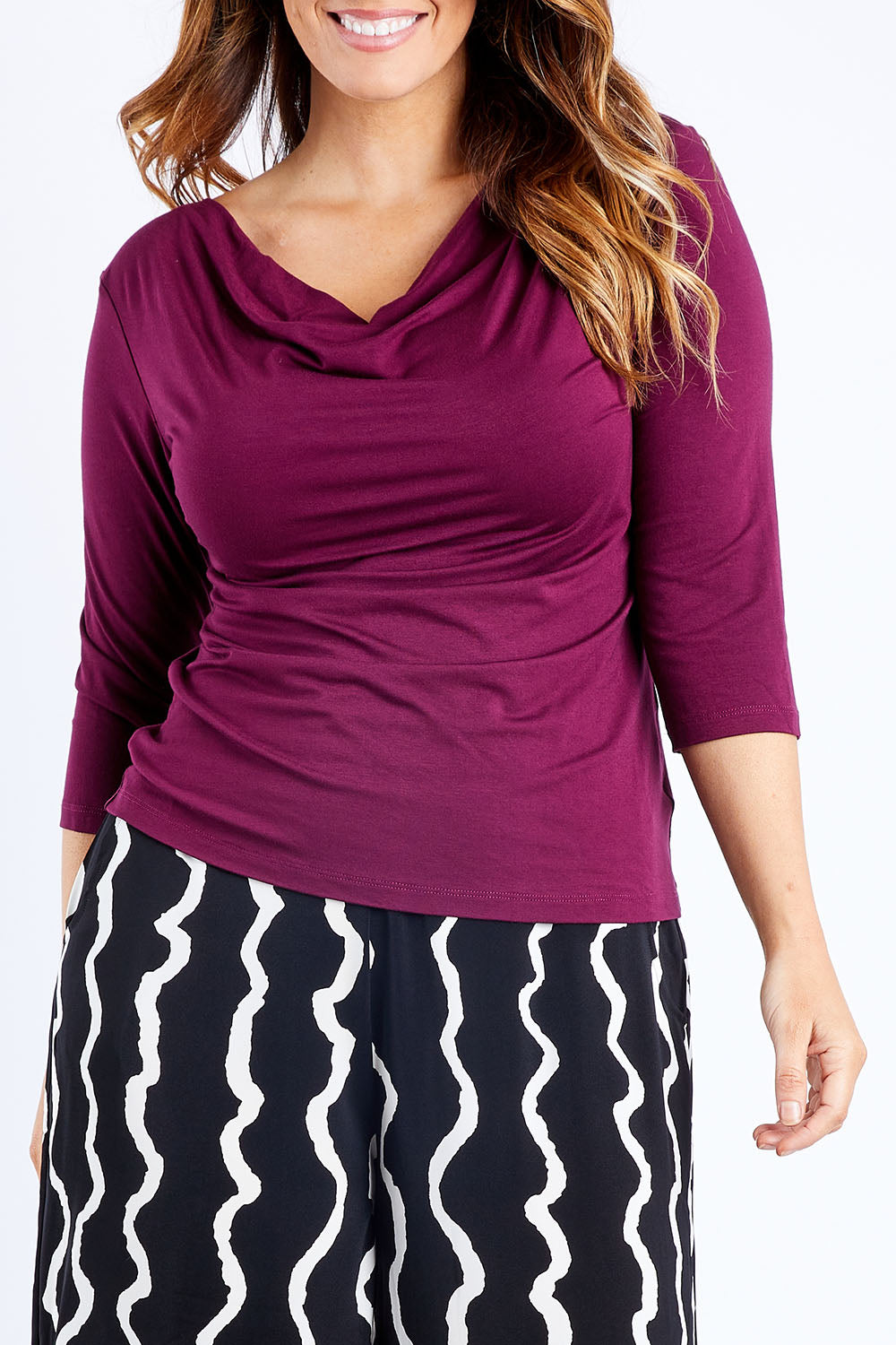 Model Laura wearing size 14 of The Reversible Cowl Neck Top in colour Plum (Purple), from the front, cropped image