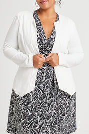Model Alexis wearing size 16 of The Adore Jacket in colour Ivory (White), from the front, cropped image
