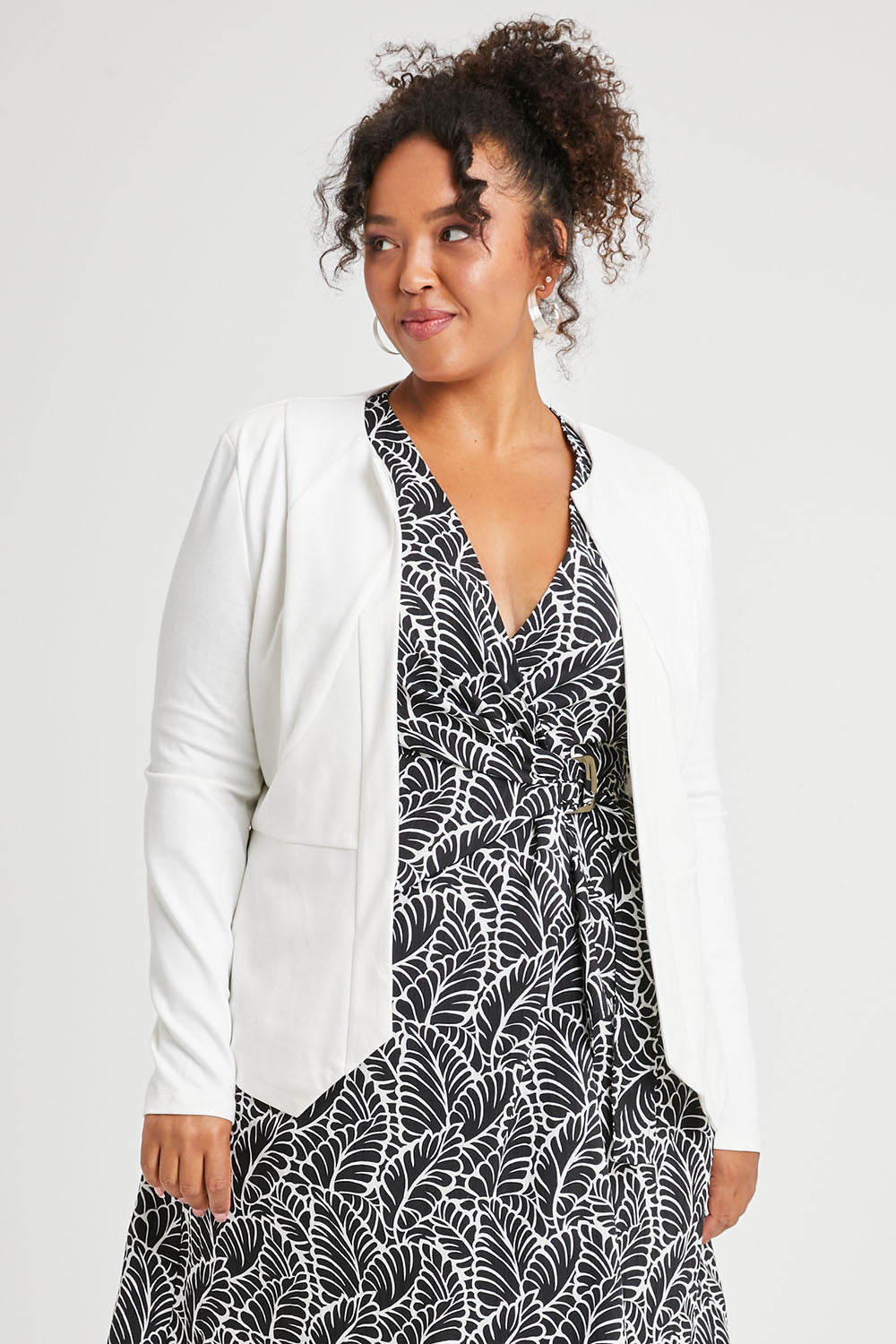 Model Alexis wearing size 16 of The Adore Jacket in colour Ivory (White), from the front, cropped image