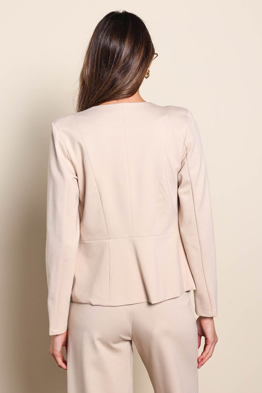 Model Madelinec wearing size 10 of the The Ponte Adore Jacket – Sand in colour Sand, from the back