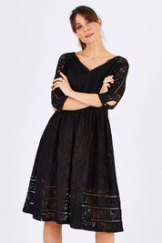 Model Monique wearing size 8 of The 3/4 Sleeve Lace Dress in colour Black (Black), from the front, cropped image