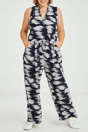 Model Fiona wearing size 16 of the Belle Printed Jumpsuit in colour Strokes (Blue), from the front, cropped image