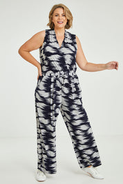 Model Fiona wearing the Belle Printed Jumpsuit in colour Strokes (Blue), from the front, showing the whole outfit