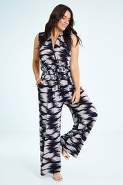 Model Laura wearing size 14 of the Belle Printed Jumpsuit in colour Strokes (Blue), from the front, showing the whole outfit