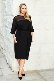 Model Jess wearing size 12 of the Belle Mesh Yoke Dress in colour Back (Black), from the front, showing the whole outfit