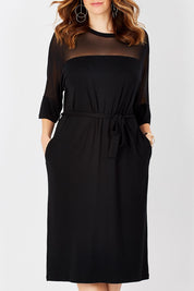 Model Laura wearing size 12 of the Belle Mesh Yoke Dress in colour Back (Black), from the front, cropped image