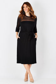 Model Laura wearing size 12 of the Belle Mesh Yoke Dress in colour Back (Black), from the front, showing the whole outfit