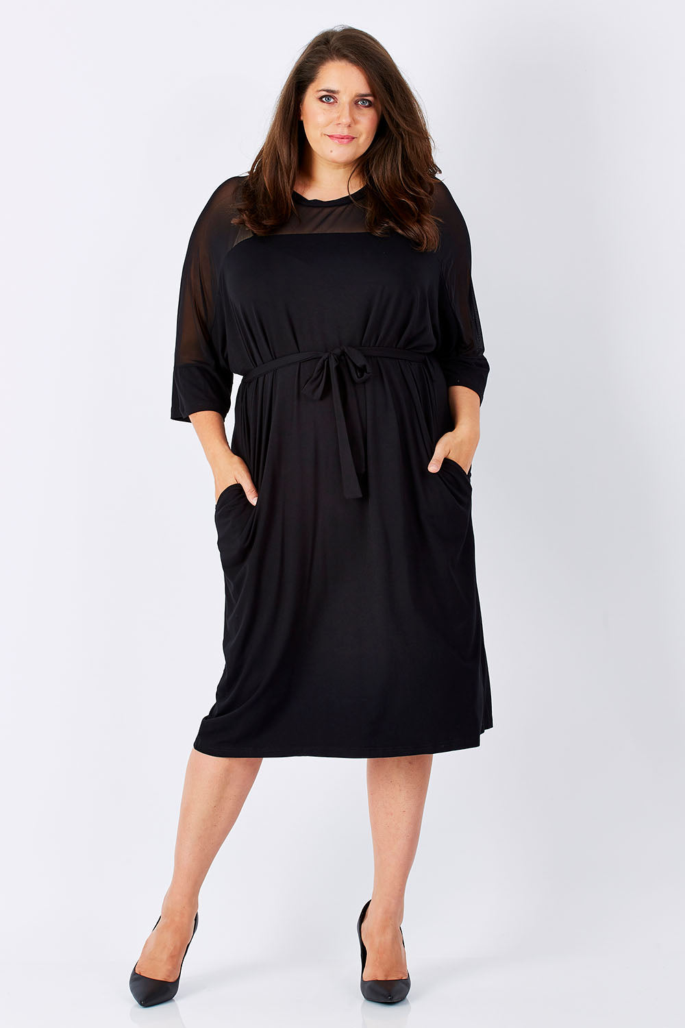 Model Mae wearing size 16 of the Belle Mesh Yoke Dress in colour Back (Black), from the front, showing the whole outfit