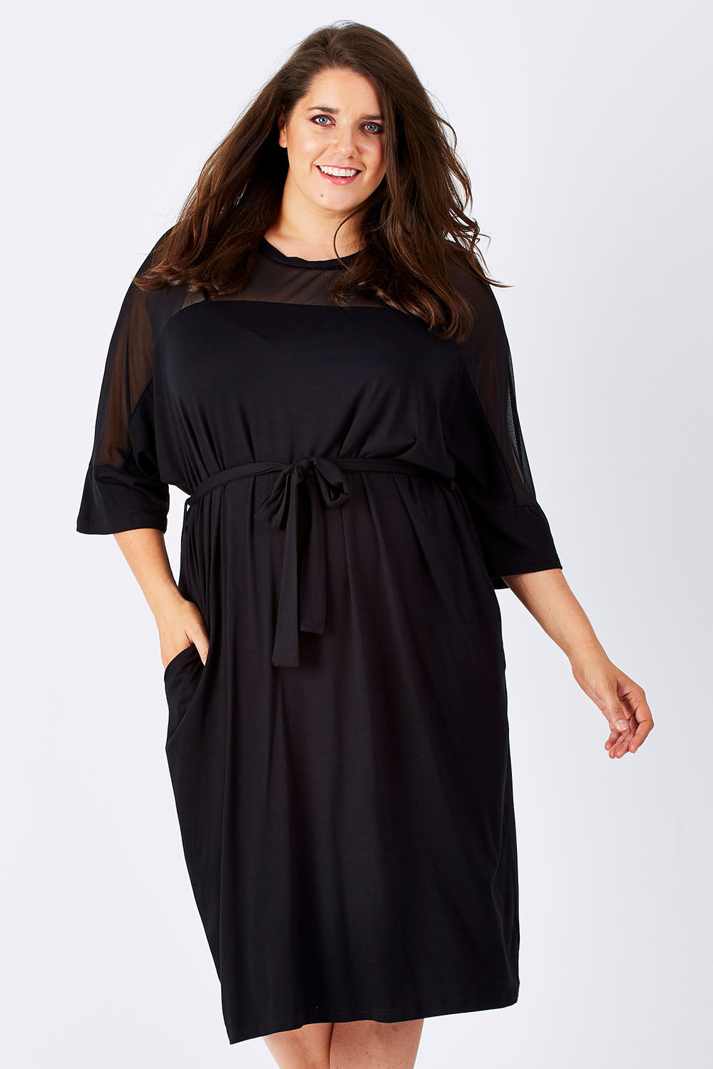 Model Mae wearing size 18 of the Belle Mesh Yoke Dress in colour Back (Black), from the front, cropped image