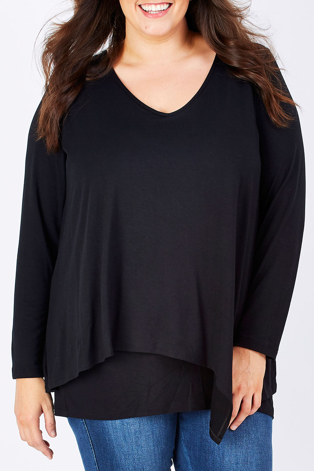 Model Mae wearing size 16 of the Belle V Neck Forgiver Tunic in colour Black (Black), from the front, cropped image