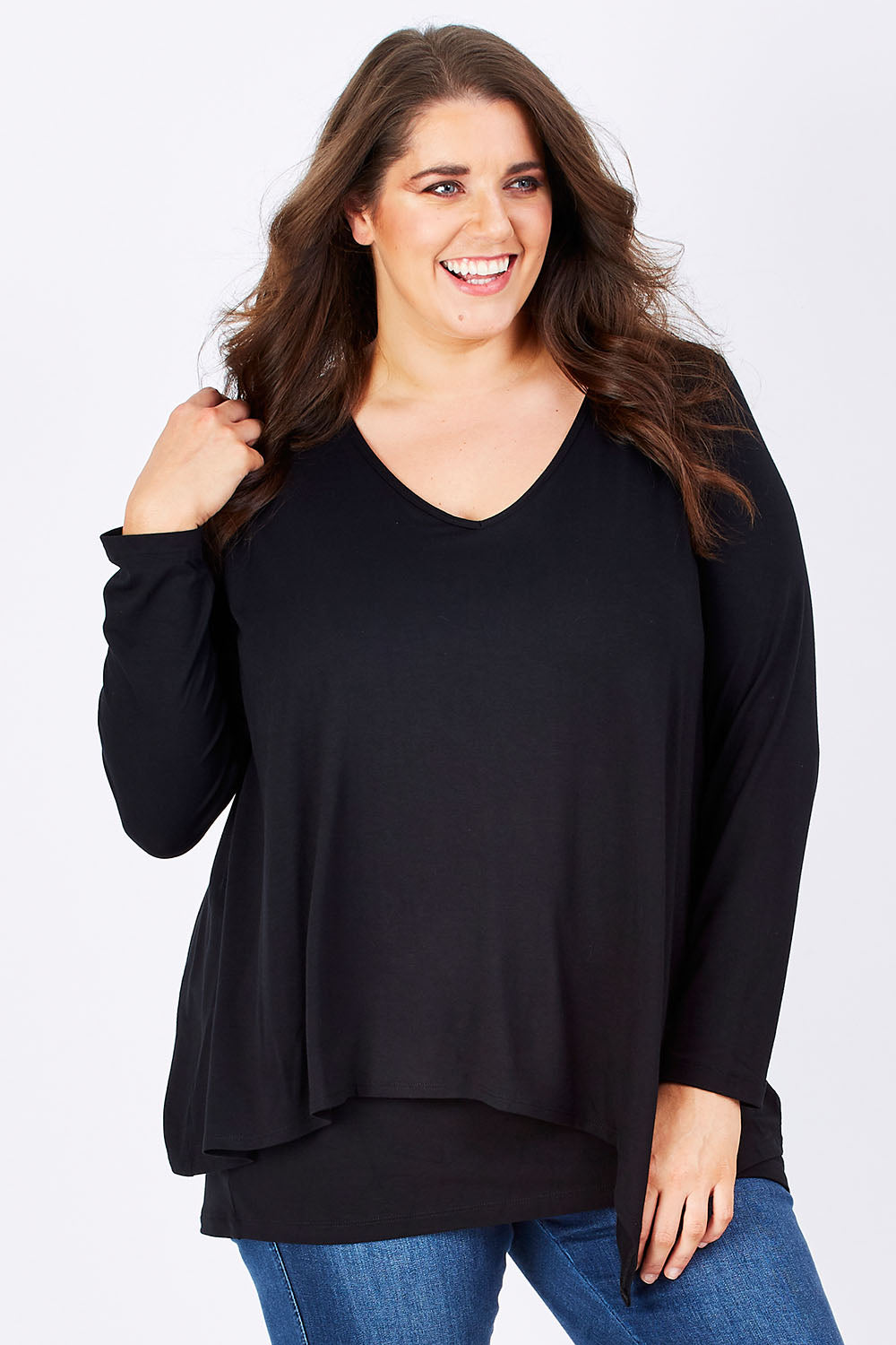 Model Mae wearing size 16 of the Belle V Neck Forgiver Tunic in colour Black (Black), from the front, cropped image