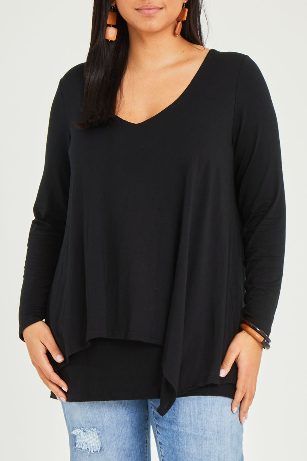 Model Terri-Leigh wearing size 14 of the Belle V Neck Forgiver Tunic in colour Black (Black), from the front, cropped image