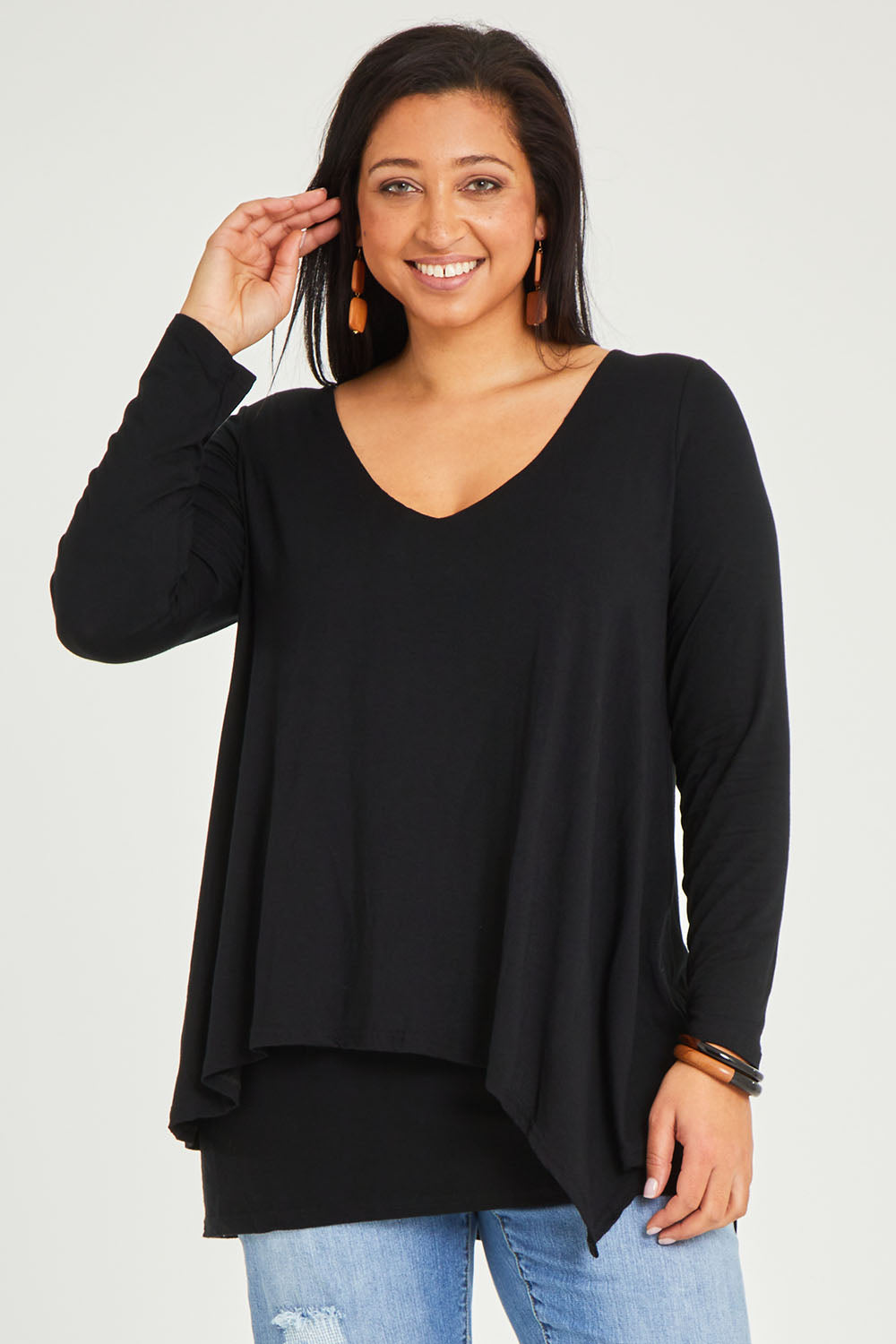 Model Terri-Leigh wearing size 14 of the Belle V Neck Forgiver Tunic in colour Black (Black), from the front, cropped image